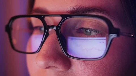 Close-up of eyes with glasses. Reflection of Web pages in the lenses of glasses Stock Footage 303013803