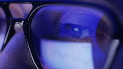 Close-up of eyes with glasses. Reflection of Web pages in the lenses of glasses Stock Footage 303013946