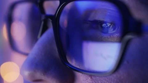 Close-up of eyes with glasses. Reflection of Web pages in the lenses of glasses Stock Footage 314333582