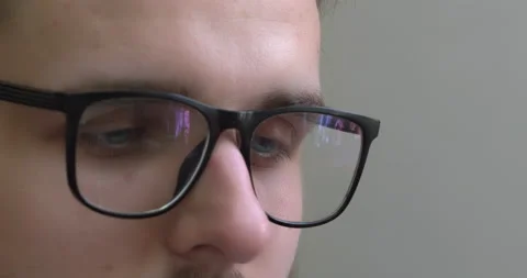 Close-up on eyes, guy in eyeglasses, focused look. Stock Footage 223976436