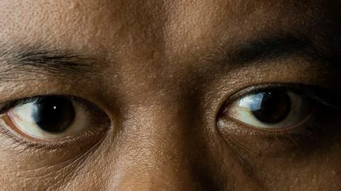 Close up of eyes looking forward, with a flat expression Stock Photos