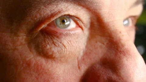 Close up of eyes of the man. Blinks and looks in the parties. Video stock 85574205