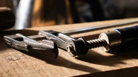 Close up F-clamp tool in a workshop. Stock Photos