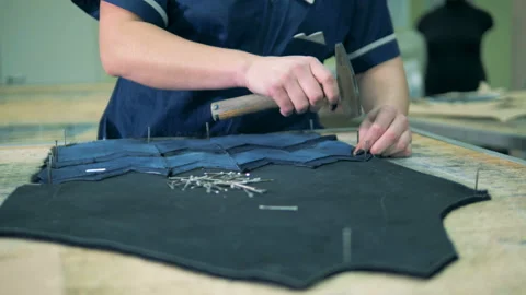 Close up of fabric elements getting nailed into a pattern Stock Footage 98696397