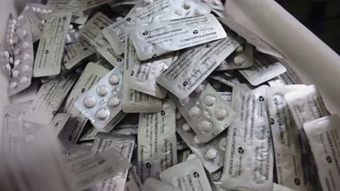The close-up of fabricated batch of pills filled and packaged in blister pack. Stock Footage 199683426