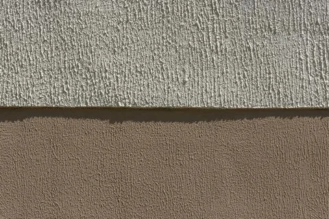 Close-up of the facade of a building plastered with two types of relief plast Stock Photos