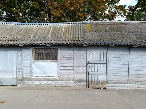 Close up facade of an old rustic wooden barn with a slate roof Stock Photos
