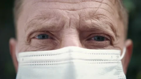 Close-up face of aged man wearing medical protective face mask. Stock Footage 139282896