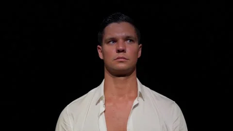 Close-up face and shoulders of young man, anxiously, fearfully, tensely and Stock-Footage 166332486