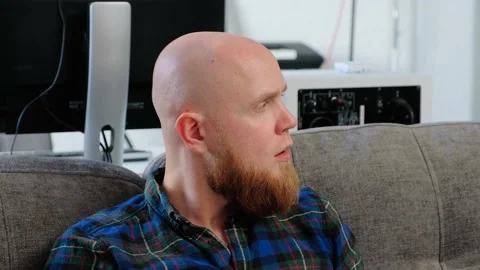 Close-up of the face of a bald man with a red beard who is thinking. Video stock 139191608