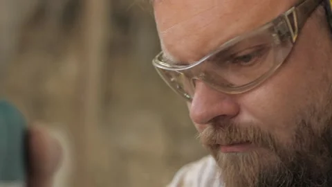 Close-up face of bearded man wearing safety glasses. worker wearing safety gl Stock Footage 137149828