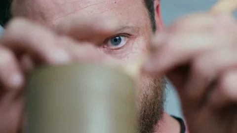 Close-up of face a bearded potter working on a potter's wheel Stock Footage 145535002