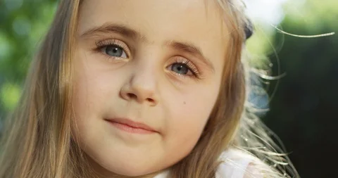 Close up of the face of the beautiful blond small and cute girl who looking in 스톡 동영상 98096971