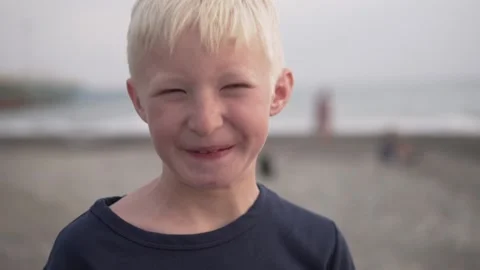Close-up of the face of a beautiful blonde boy against the background of the Stock Footage 142314280