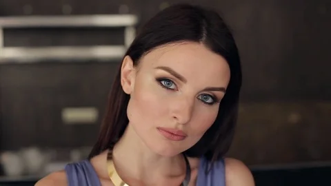 Close-up face of a beautiful brunette with makeup. Stock Footage