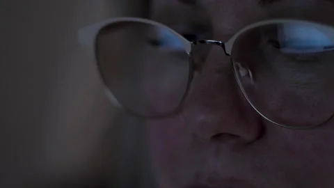 Close-up face of a blonde 40-45 years old uses a computer, the monitor is r.. Stock Footage 233170001