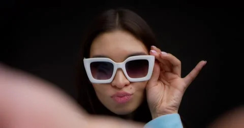 Close-up of the face of a brunette in glasses taking a selfie on a smartphone. Stock Footage 170448134