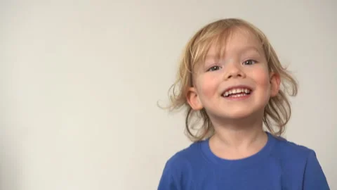Close-up face of charming little blond boy with blue eyes. Portrait of cute Stock Footage 169099655