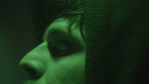 Close-Up Face of Computer Hacker or Programmer at Computer with Green Lights Stock Footage 234215528