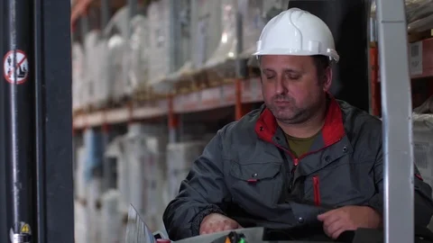 Close-up. The face of the driver of a forklift. A man works in a logistics Stock Footage 111768364