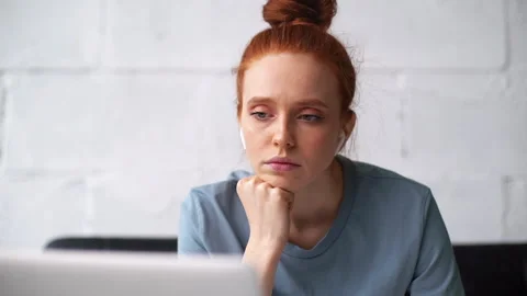 Close-up face of exhausted sleepy redhead young businesswoman working on laptop Video stock 133238677