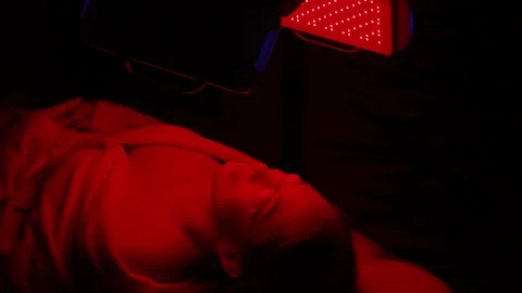 Close-up face of female client lying during non-invasive type of phototherapy Stock Footage 266238777