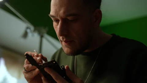 Close-up face of focused technician cleaning delicate motherboard components Stock Footage 301401495