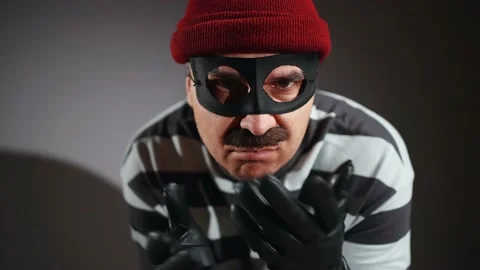 Close-up of the face funny thief in mask and Prison Uniform Stock-Footage 224081842