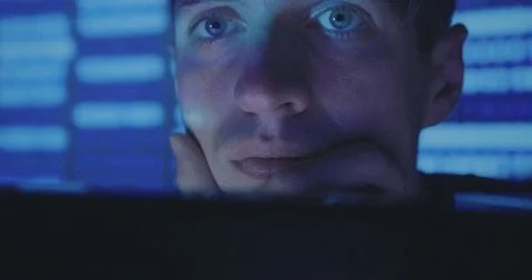 Close up face of Hacker programmer is working on computer writing the code in Stock Footage 95709038