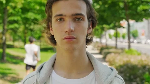 Close up face of  handsome guy with sad eyes, in the nature. Stock Footage 305828850