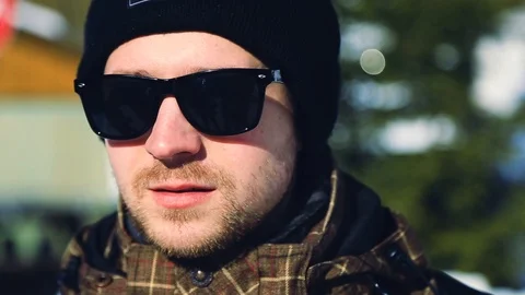 Close up face handsome stylish man in sunglasses looking at camera outdoors Video stock 105265613