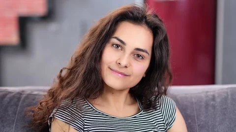 Close-up face of happy beautiful fresh young woman with pure skin and curly hair Video stock 109236331