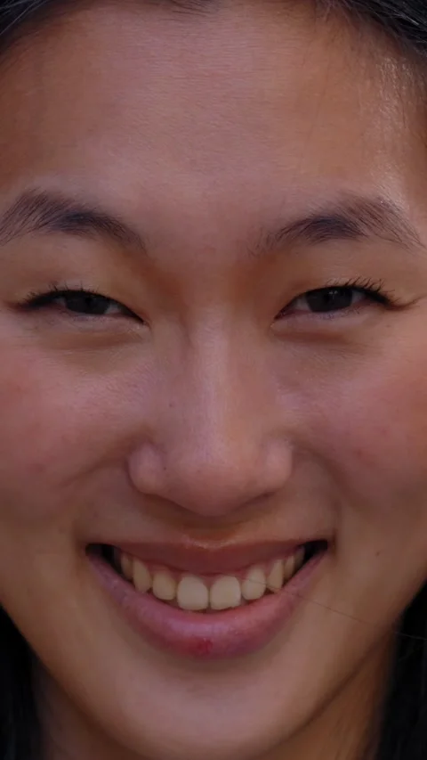 Close up face of happy beautiful young Asian woman happy smiling on street Stock Footage 273835063