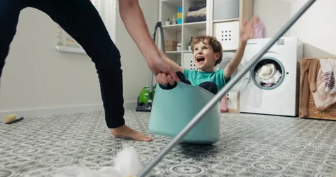 Close-up of the face of a happy, laughing boy sitting in a plastic laundry bowl Stock-Footage 201255428