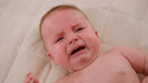 Close-up face of infant crying. Caucasian baby yelling. Child crying. Stock Footage 221117015