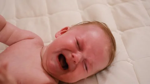Close-up face of infant crying. Caucasian baby yelling. Child crying. Stock Footage 260481436
