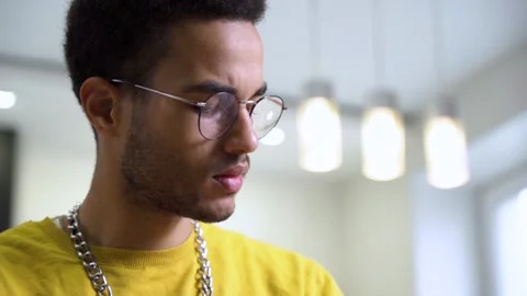 A close-up of the face of an intelligent young African with glasses. Stock Footage 166453255