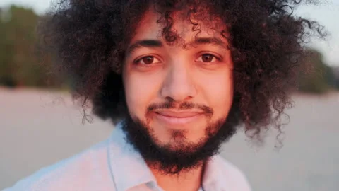 Close-up Face of Kind and Friendly Male Brazilian Person with Curly Hair. He Stock Footage 148551368