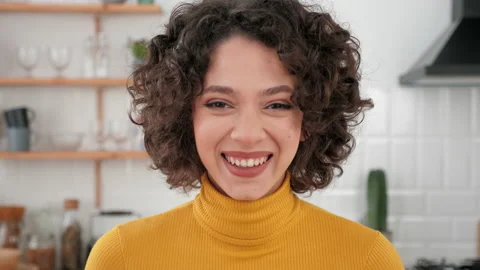 Close up face laughing hispanic curly woman looking camera at home kitchen Stock Footage 192968607