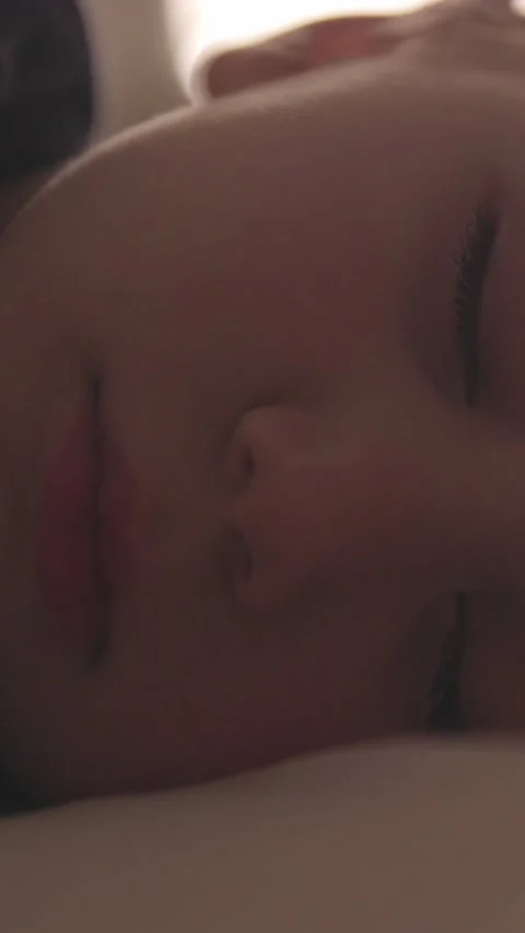 Close-up of the face of a little blond boy sleeping in his bed and breathing Stock Footage 328222428
