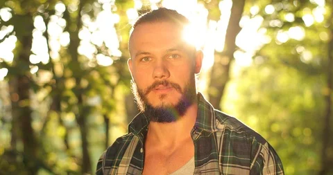 Close-up the face of a man with a beard looks straight into the camera. looks Stock Footage 126496853