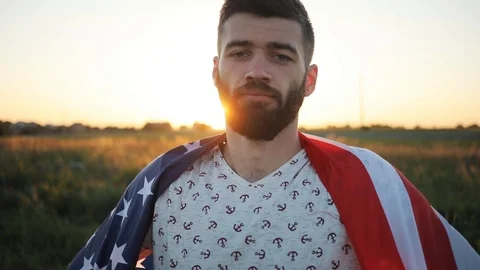 Close up face man holding the flag of America in the field look at camera smile Stock Footage 92066271
