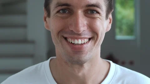 Close-up face of a man pleasantly surprised. Portrait of a surprised happy man Stock Footage 245843232