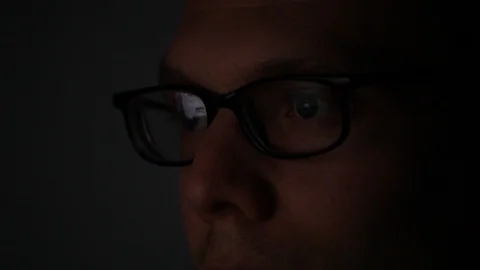 Close up of face of man programmer working on computer by night Stock Footage 98093819