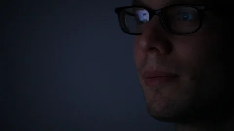 Close up of face of man programmer working on computer by night Stock Footage 98093865
