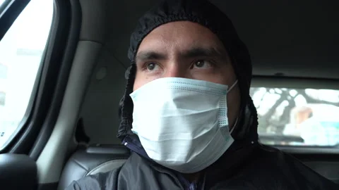 Close-up of the face of a man protected with a Boilersuit  inside a car Video stock 140310829