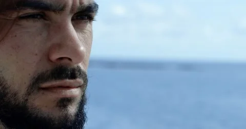 Close-up of the face of a man from the side with a beard and long brown hair. We 스톡 동영상 154693385