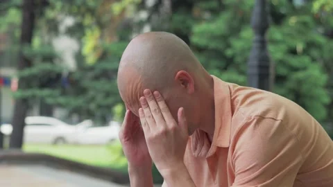 Close-up of the face of a man suffering from a headache, holding his hands to Stock Footage 154756957