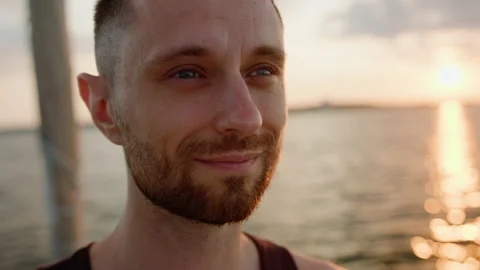 Close-up of the face of a man who rides a yacht during sunset Stock Footage 201191777