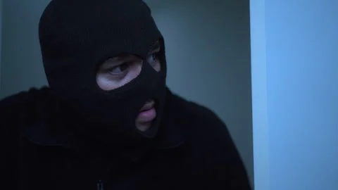 Close-up of face masks thief opening the house's door while entering. Stock Footage 277352282